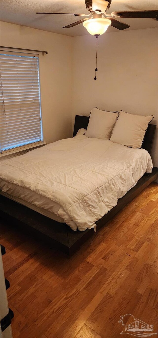 unfurnished bedroom with wood finished floors and ceiling fan