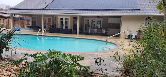 view of swimming pool with french doors, a ceiling fan, a fenced in pool, fence, and a patio