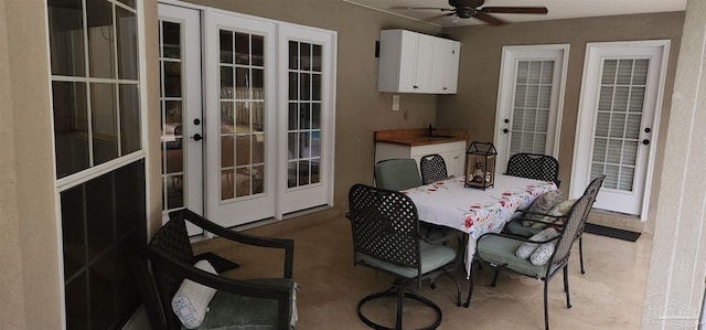 dining room featuring ceiling fan and french doors