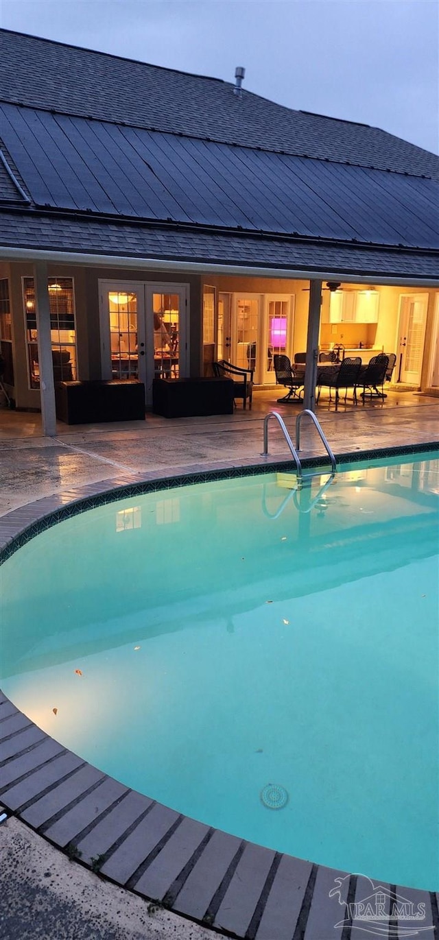pool with outdoor lounge area, french doors, and a patio area