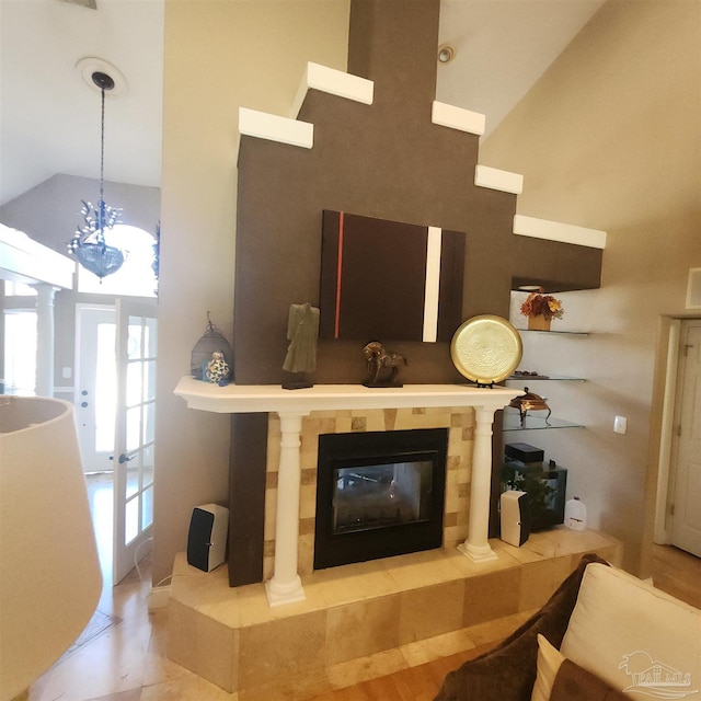 living room featuring a fireplace and a towering ceiling