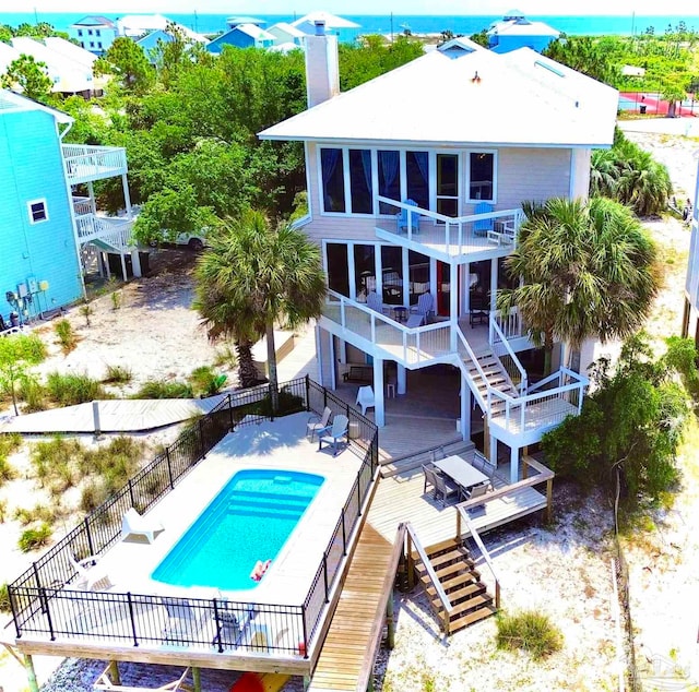 view of swimming pool with a wooden deck and a patio