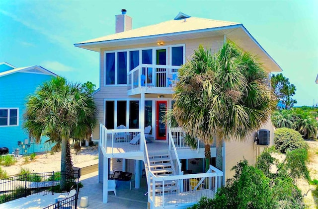 rear view of house featuring a deck and cooling unit