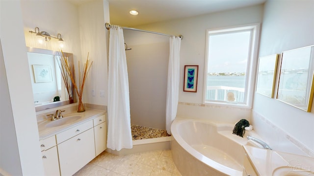 bathroom with tile patterned flooring, independent shower and bath, a water view, and vanity