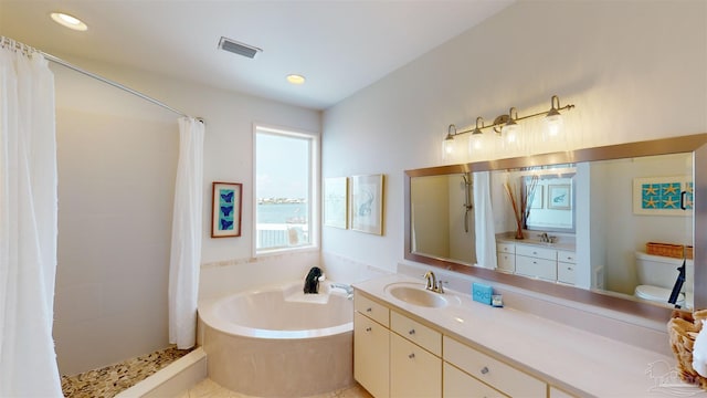 full bathroom with tile patterned flooring, shower with separate bathtub, toilet, and vanity