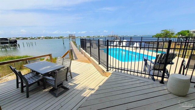 exterior space with a water view and a covered pool