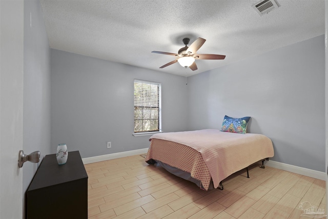 bedroom featuring baseboards, visible vents, and light wood-style flooring