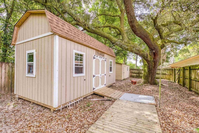 view of outdoor structure featuring an outbuilding and a fenced backyard