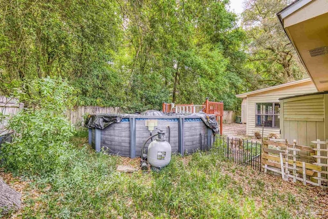 view of yard with a fenced in pool and fence