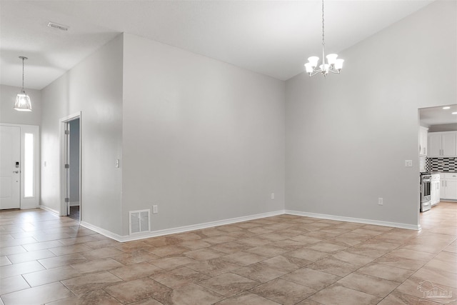 interior space featuring a high ceiling and an inviting chandelier