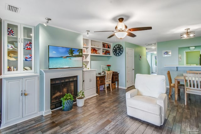 living room featuring ceiling fan and dark hardwood / wood-style flooring