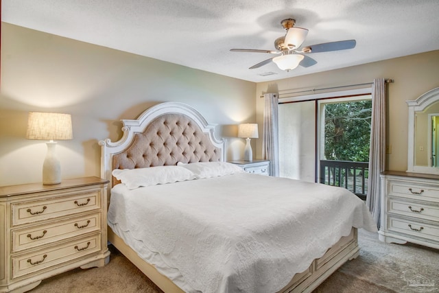 carpeted bedroom with a textured ceiling, access to exterior, and ceiling fan