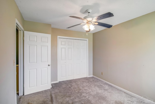 unfurnished bedroom with light carpet, ceiling fan, and a closet