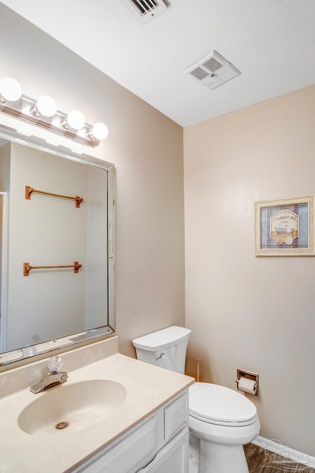 bathroom featuring vanity and toilet