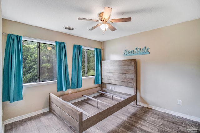 bedroom with hardwood / wood-style floors and ceiling fan