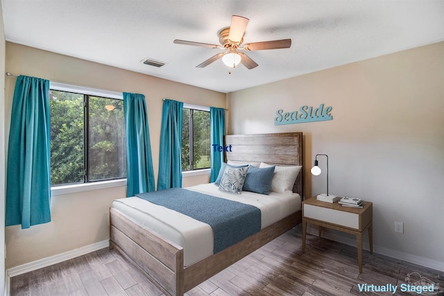 bedroom with wood-type flooring and ceiling fan