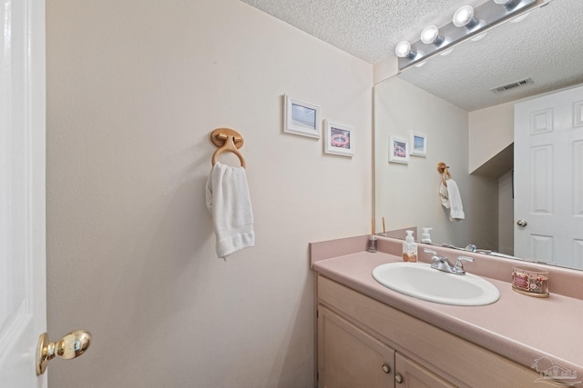 bathroom with vanity and a textured ceiling