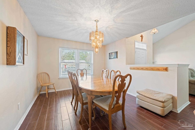 dining area featuring lofted ceiling, a chandelier, a textured ceiling, and dark hardwood / wood-style flooring