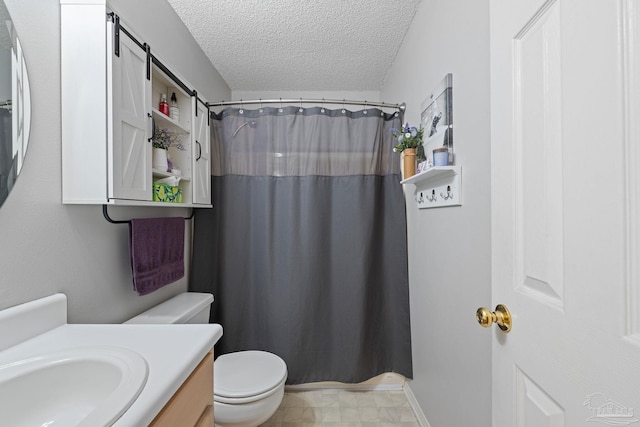 bathroom featuring vanity, a shower with shower curtain, a textured ceiling, and toilet