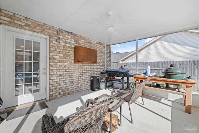 sunroom featuring ceiling fan