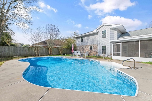 view of pool with a patio area and a sunroom