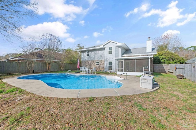 view of pool with a yard, a sunroom, and a patio