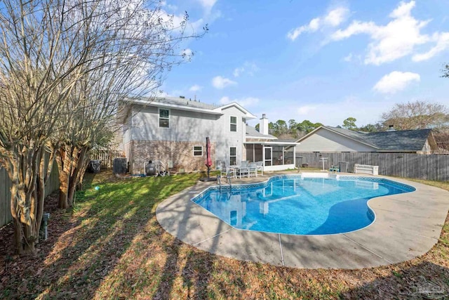 view of pool with central AC unit, a sunroom, and a lawn