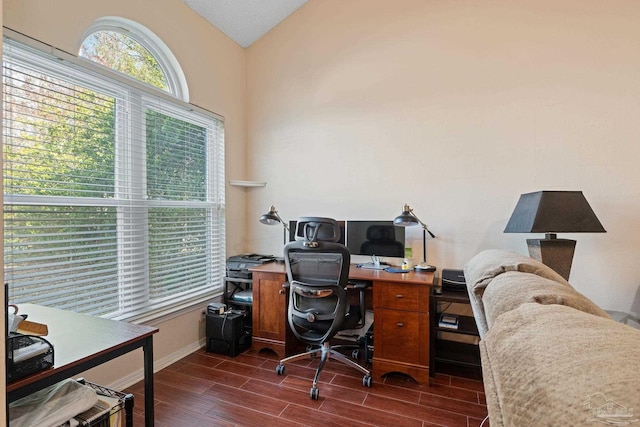 home office featuring lofted ceiling and dark hardwood / wood-style floors