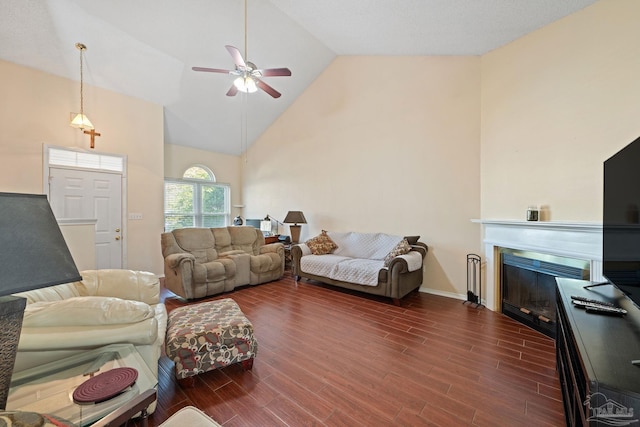 living room with dark wood-type flooring, ceiling fan, and high vaulted ceiling