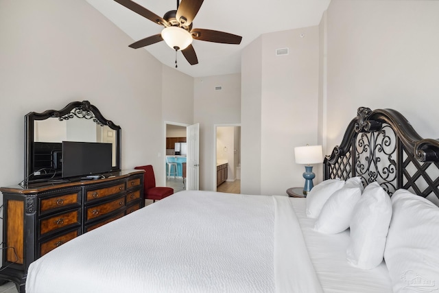 bedroom featuring ensuite bathroom, ceiling fan, and high vaulted ceiling