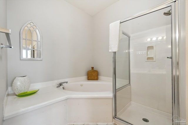 bathroom featuring shower with separate bathtub