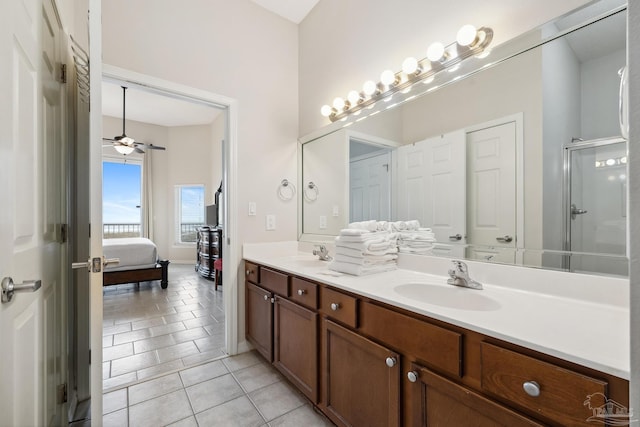 bathroom with tile patterned flooring, vanity, ceiling fan, and a shower with shower door