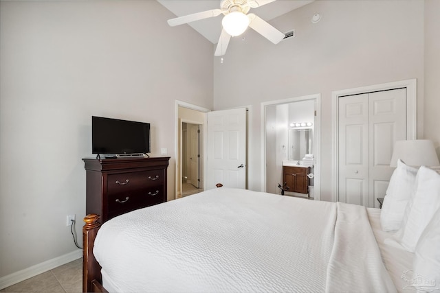 tiled bedroom featuring connected bathroom, high vaulted ceiling, and ceiling fan