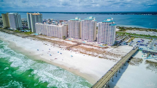 drone / aerial view featuring a water view and a view of the beach