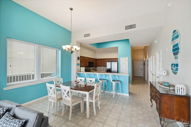 dining room featuring a chandelier and light tile patterned flooring