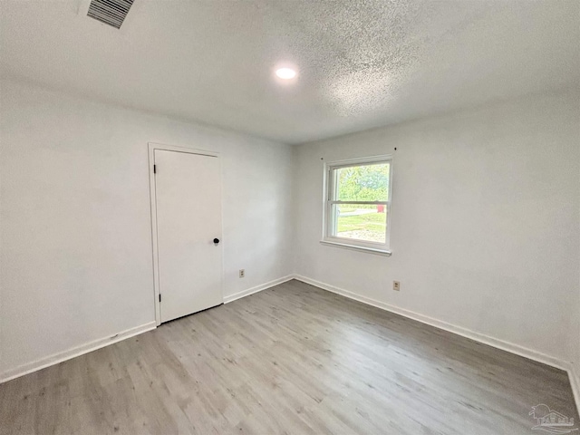 5737 Chumuckla Hwy, Pace, FL 32571 - empty room with wood finished floors, baseboards, a textured ceiling, and recessed lighting