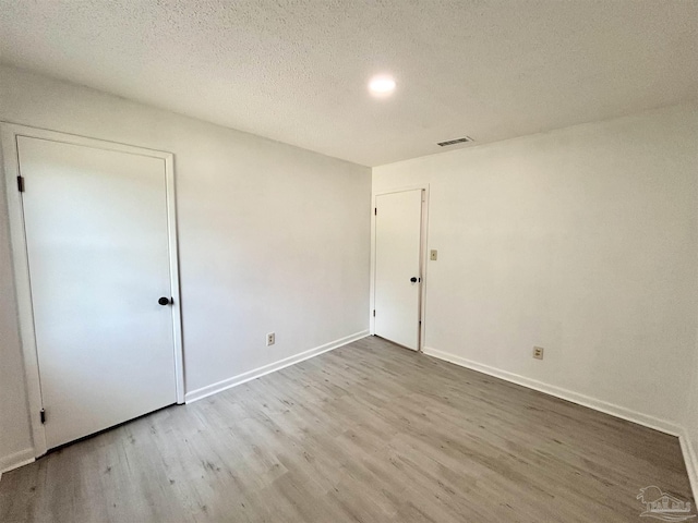 5737 Chumuckla Hwy, Pace, FL 32571 - unfurnished bedroom featuring wood finished floors, baseboards, and a textured ceiling