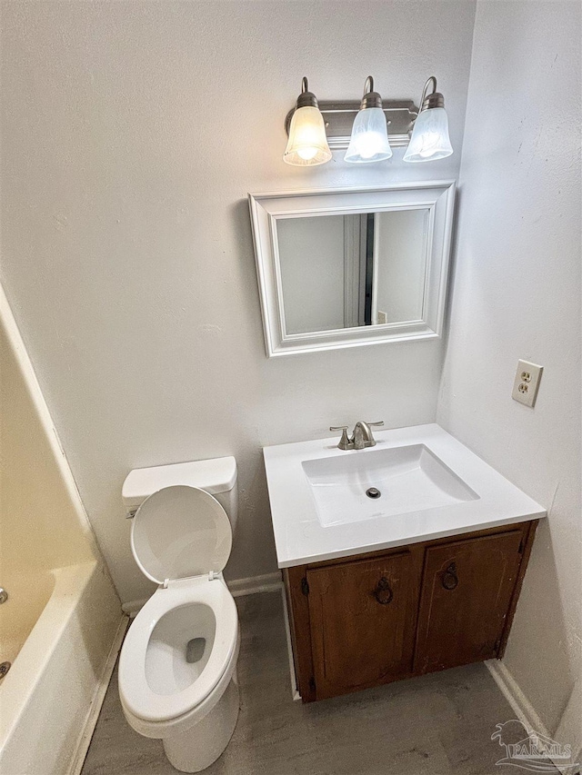 5737 Chumuckla Hwy, Pace, FL 32571 - bathroom featuring vanity, toilet, a bathtub, and baseboards