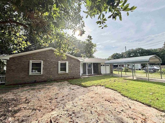 5737 Chumuckla Hwy, Pace, FL 32571 - rear view of house featuring brick siding, a lawn, and a detached carport