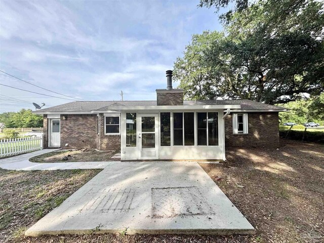 5737 Chumuckla Hwy, Pace, FL 32571 - rear view of property with brick siding, a patio area, a chimney, and a sunroom