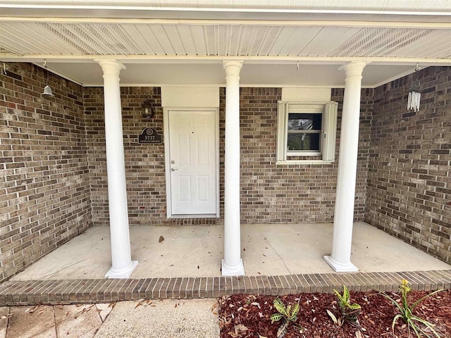 5737 Chumuckla Hwy, Pace, FL 32571 - view of exterior entry with a porch and brick siding