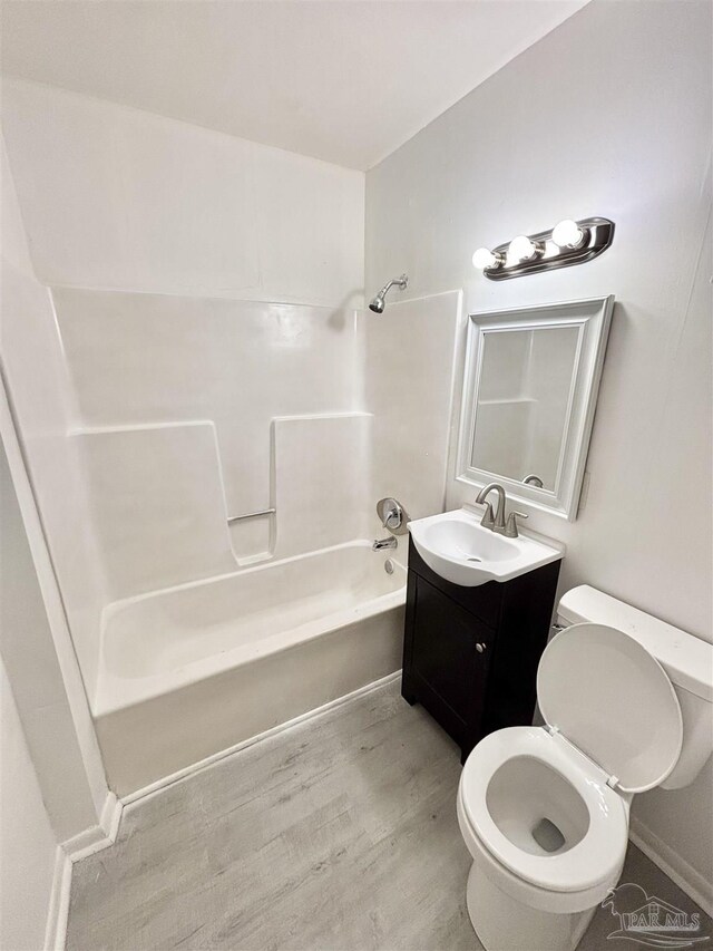 5737 Chumuckla Hwy, Pace, FL 32571 - full bath with shower / washtub combination, vanity, toilet, and wood finished floors