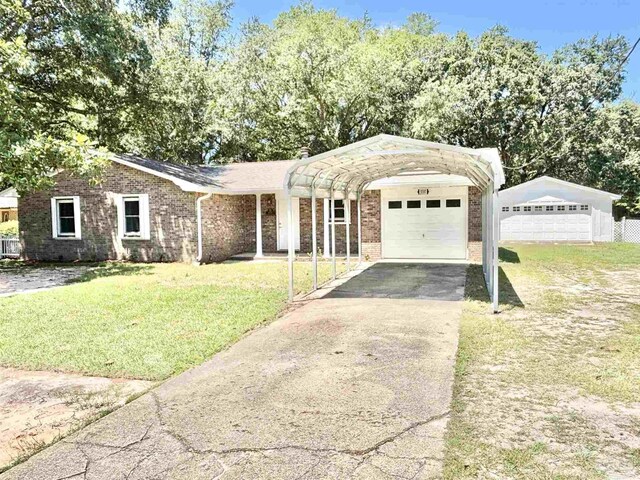 5737 Chumuckla Hwy, Pace, FL 32571 - ranch-style house with a front lawn, a detached carport, brick siding, a detached garage, and driveway