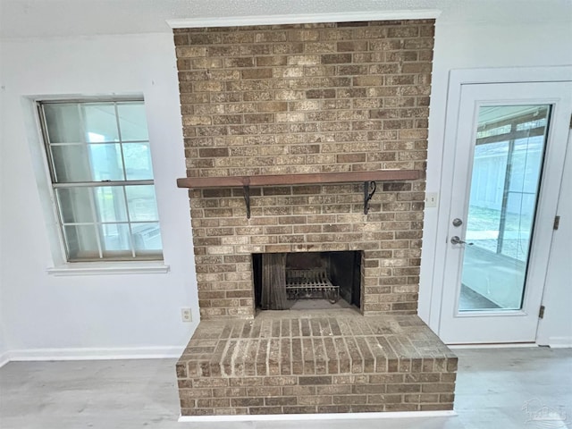 5737 Chumuckla Hwy, Pace, FL 32571 - detailed view of a fireplace, wood finished floors, and baseboards