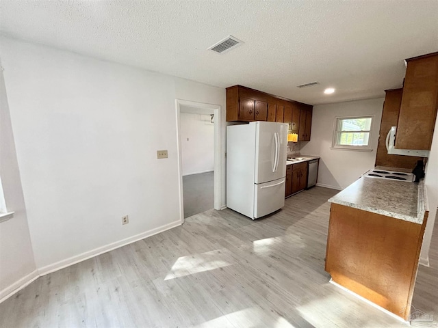 5737 Chumuckla Hwy, Pace, FL 32571 - kitchen featuring freestanding refrigerator, light wood-type flooring, light countertops, dishwasher, and baseboards