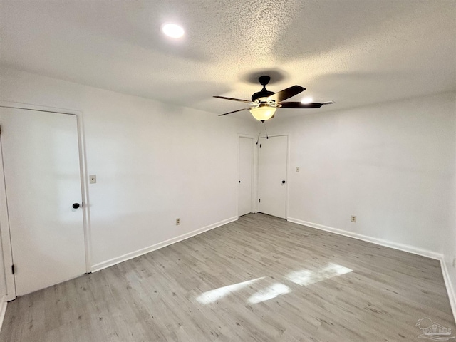 5737 Chumuckla Hwy, Pace, FL 32571 - empty room with ceiling fan, light wood-style flooring, baseboards, and a textured ceiling