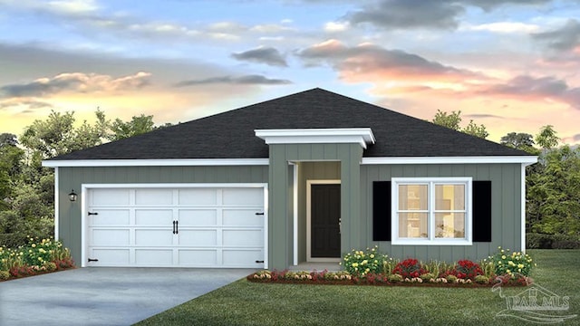 view of front of home with board and batten siding, concrete driveway, a yard, and an attached garage