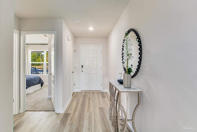 foyer featuring light wood-style floors and baseboards