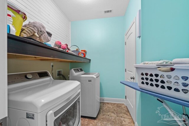 clothes washing area featuring washer and clothes dryer