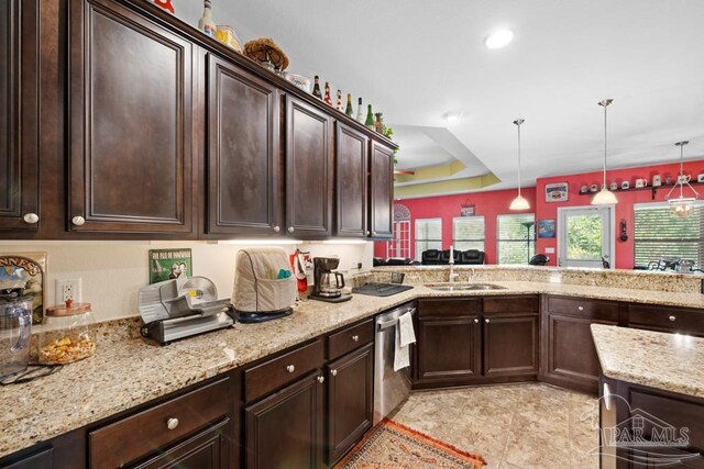 kitchen with kitchen peninsula, dark brown cabinets, stainless steel dishwasher, and hanging light fixtures